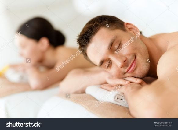 stock-photo-health-and-beauty-resort-and-relaxation-concept-couple-in-spa-salon-lying-on-the-massage-desks-160555064
